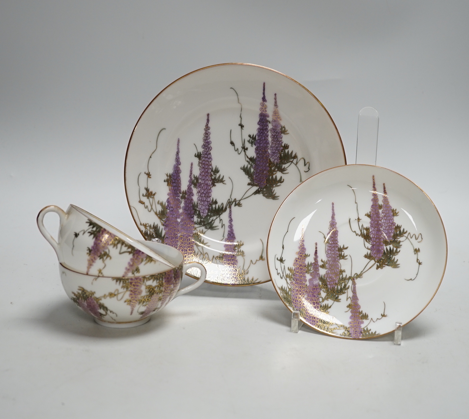 A Japanese eggshell part tea service with wisteria decoration, comprising of eight cups, eleven saucers and twelve tea plates
